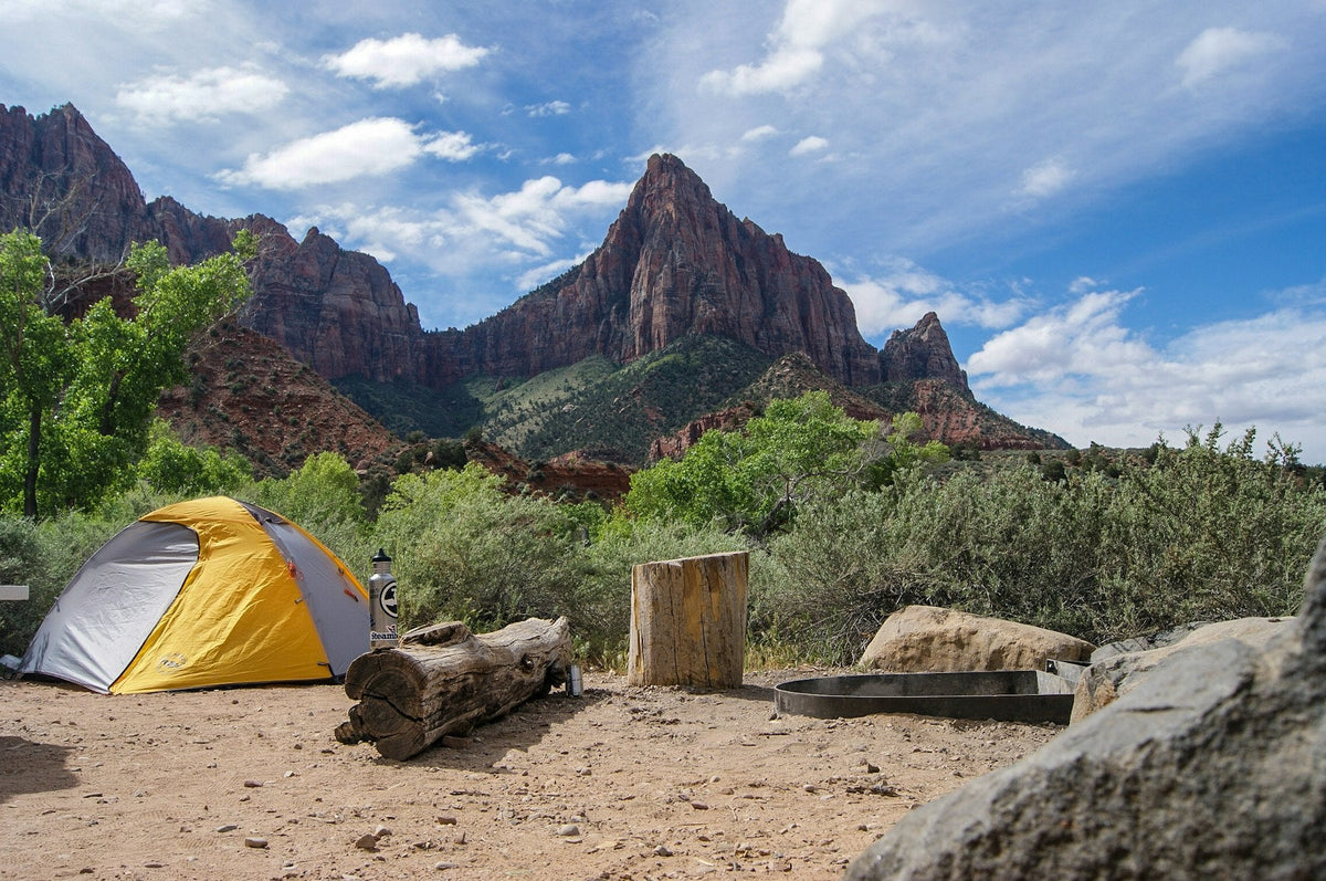 Two camping tents below red rock mountains