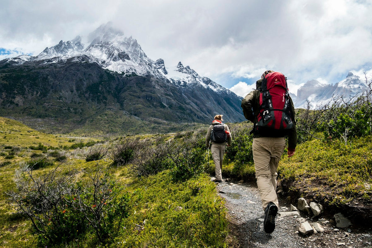 Backpackers hiking a mountain trail with full packs