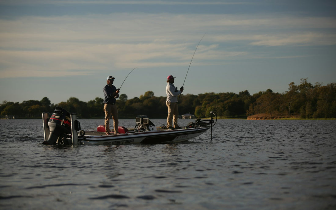 Anglers fishing from a bass boat at sunrise
