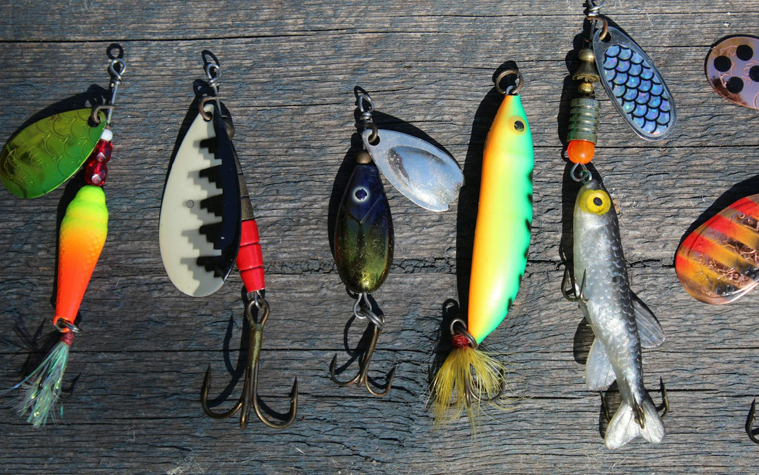 Colorful spinner lures laid out on a wooden table