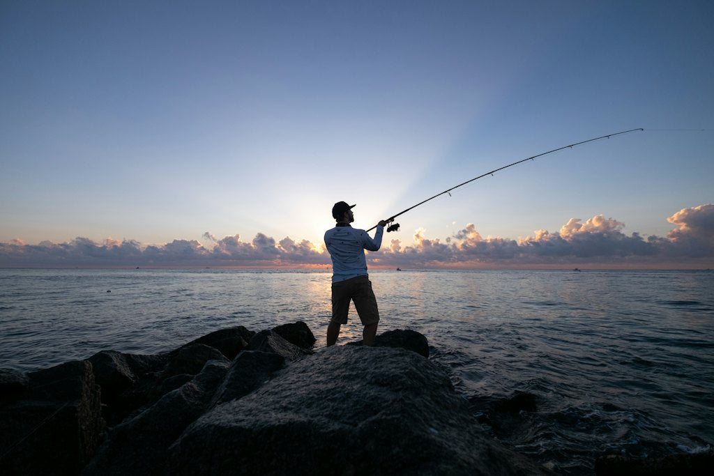 Angler casting from the rocks at first light